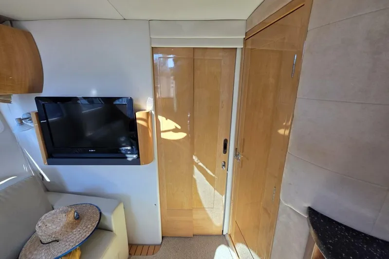  Yacht Photos Pics Interior of 2009 Four Winns V435 yacht with TV, wooden doors, and seating area.