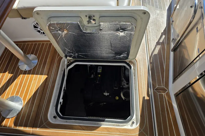  Yacht Photos Pics Open engine compartment on 2009 Four Winns V435 boat with wooden deck.