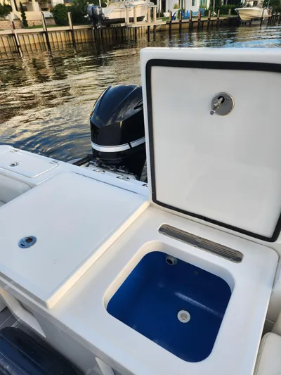  Yacht Photos Pics 2019 HCB 39 Speciale boat with open storage compartment by the water.