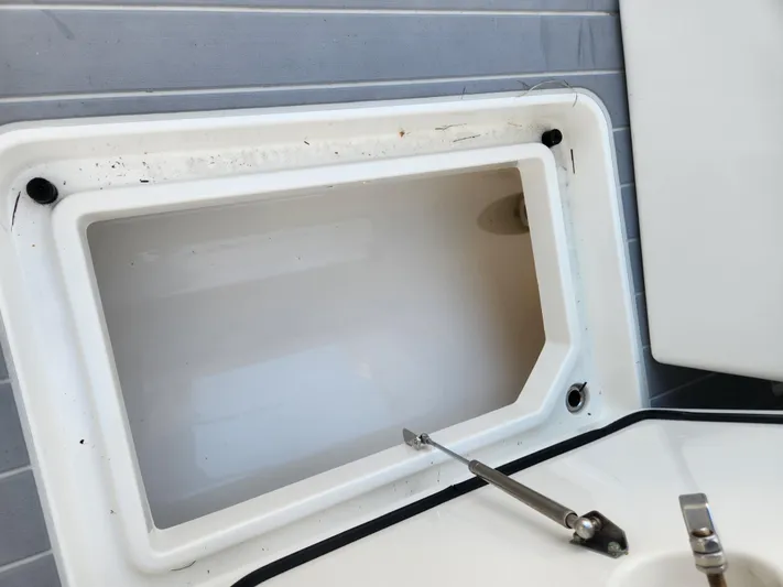  Yacht Photos Pics Open storage compartment on a 2019 HCB 39 Speciale boat, showing interior details.