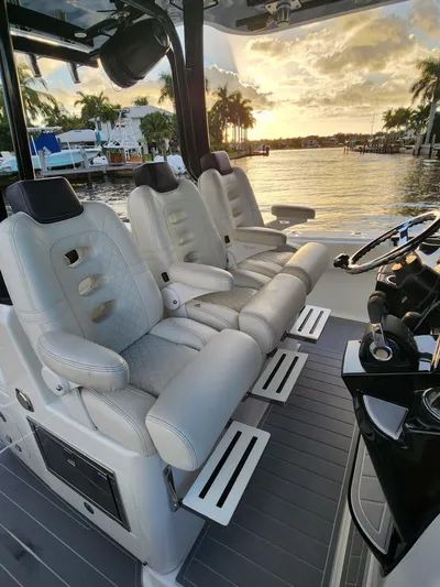  Yacht Photos Pics Luxurious seating on 2019 HCB 39 Speciale boat, with sunset view over water.