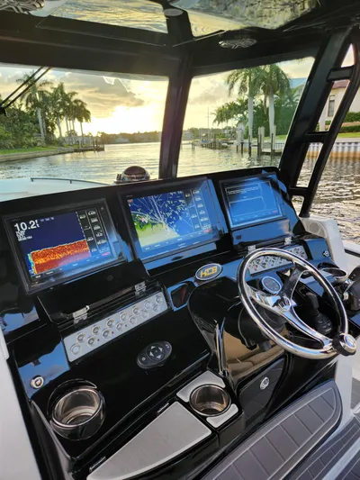  Yacht Photos Pics 2019 HCB 39 Speciale boat dashboard with advanced navigation screens at sunset.