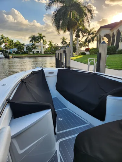  Yacht Photos Pics 2019 HCB 39 Speciale boat docked by palm trees and waterfront homes.