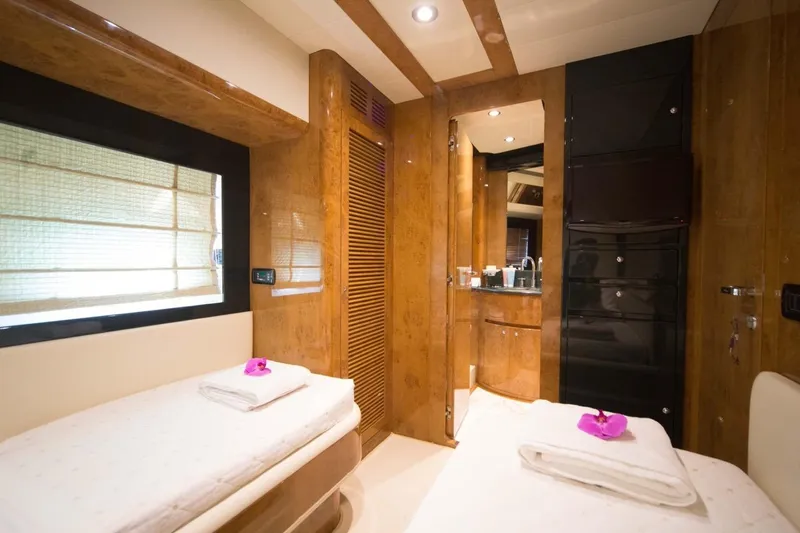 Zia Canaia Yacht Photos Pics Luxurious interior of 2001 Riva Opera 80 yacht with twin beds and elegant wood finish.