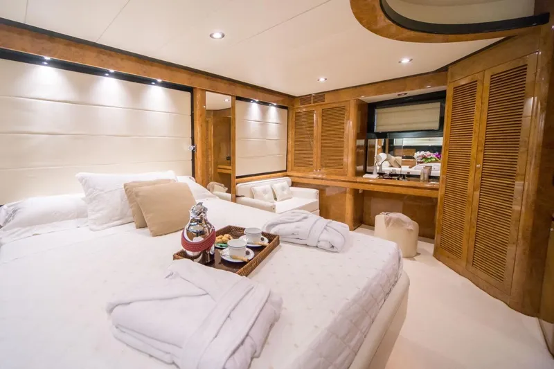 Zia Canaia Yacht Photos Pics Luxurious bedroom interior of 2001 Riva Opera 80 yacht with elegant wood finishes.