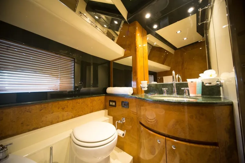 Zia Canaia Yacht Photos Pics Luxurious bathroom interior of 2001 Riva Opera 80 yacht with elegant wood and modern fixtures.