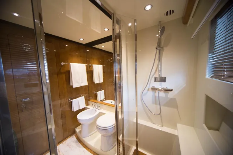 Zia Canaia Yacht Photos Pics Luxurious bathroom in 2001 Riva Opera 80 yacht with modern shower and elegant fixtures.