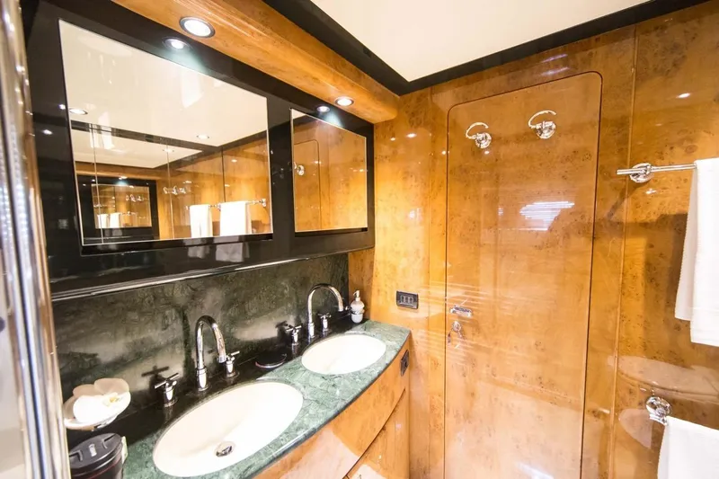 Zia Canaia Yacht Photos Pics Luxurious bathroom in 2001 Riva Opera 80 yacht with dual sinks and elegant wood finish.