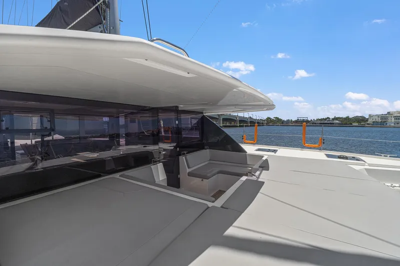 One Love Yacht Photos Pics Leopard 50 catamaran 2019 model, spacious deck with seating, docked by the water.
