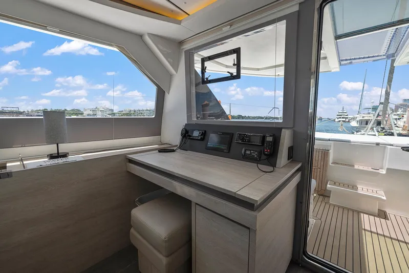 One Love Yacht Photos Pics Interior helm station of 2019 Leopard 50 yacht with navigation equipment and ocean view.