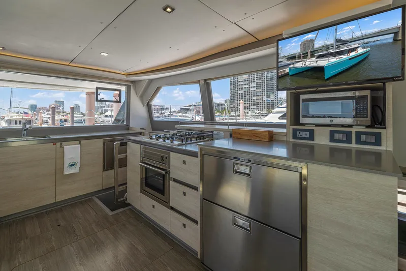 One Love Yacht Photos Pics Modern kitchen interior on a 2019 Leopard 50 yacht with stainless steel appliances.