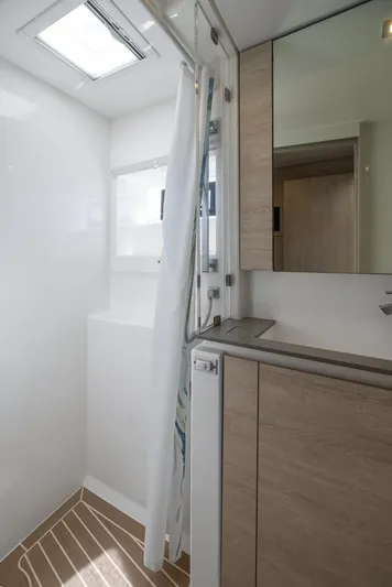 One Love Yacht Photos Pics Modern bathroom interior of 2019 Leopard 50 yacht with shower and wooden cabinets.