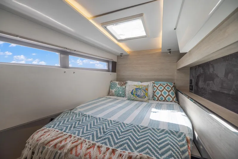 One Love Yacht Photos Pics Modern bedroom interior on Leopard 50 catamaran, 2019 model, with skylight and ocean view.