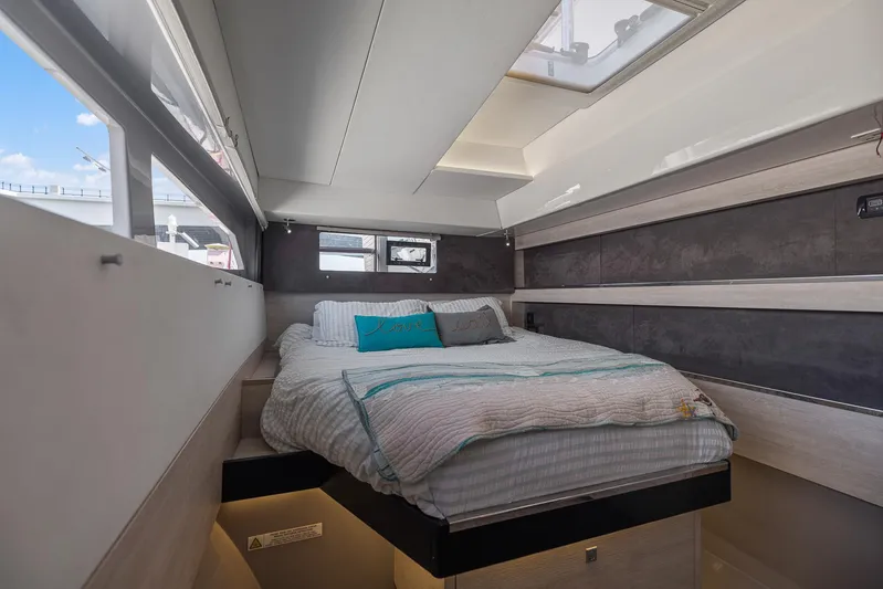 One Love Yacht Photos Pics Modern bedroom interior on a 2019 Leopard 50 yacht with skylight and cozy bedding.