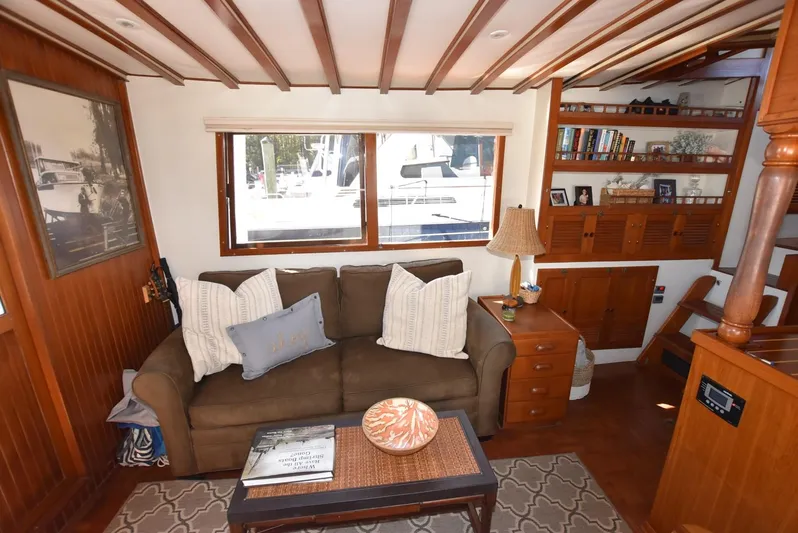 In Do Time Yacht Photos Pics 1983 Kadey-Krogen Trawler interior with cozy sofa, wooden decor, and nautical-themed accents.