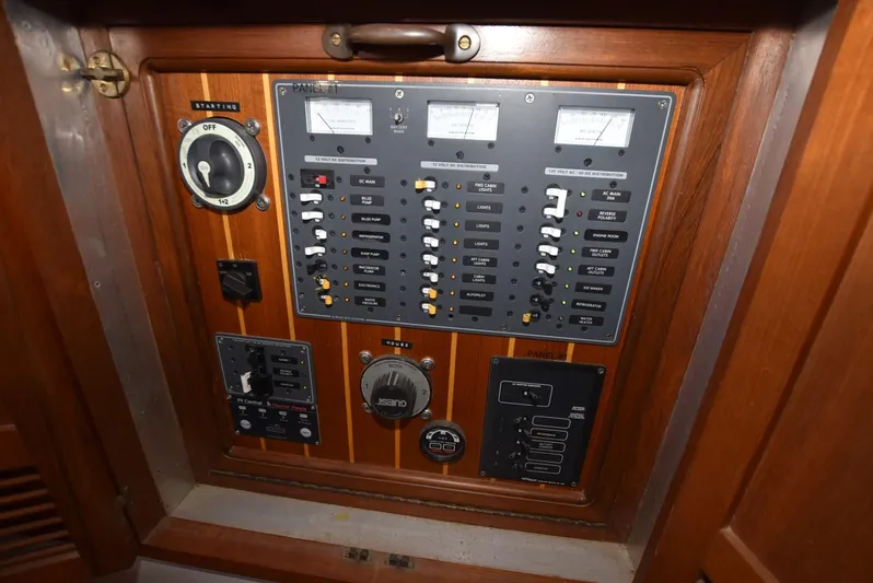 In Do Time Yacht Photos Pics Electrical control panel on a 1983 Kadey-Krogen Trawler, featuring gauges and switches.