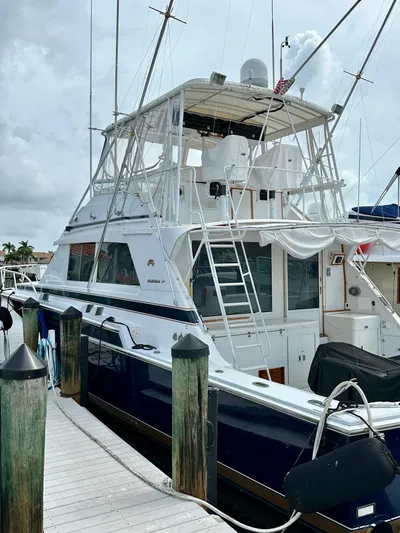 Farbrengen Yacht Photos Pics 1982 Bertram 54 Convertible yacht docked at a marina, showcasing its classic design.
