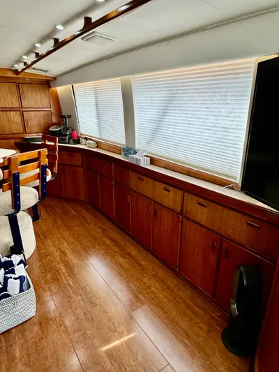 Farbrengen Yacht Photos Pics Interior of a 1982 Bertram 54 Convertible yacht with wooden cabinetry and seating.