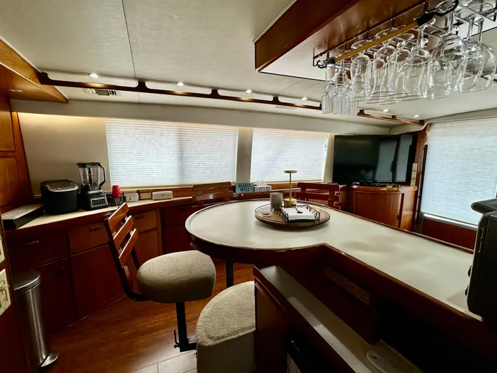 Farbrengen Yacht Photos Pics Interior of 1982 Bertram 54 Convertible yacht with modern kitchen and dining area.