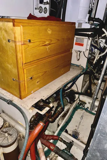 Farbrengen Yacht Photos Pics Engine room of 1982 Bertram 54 Convertible with wooden box and visible wiring.