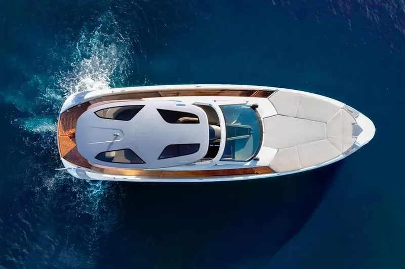  Yacht Photos Pics Aerial view of 2017 Tecnomar Evo 55 yacht cruising on blue water.