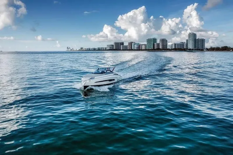  Yacht Photos Pics Tecnomar Evo 55 yacht cruising on blue ocean near city skyline, 2017 model.