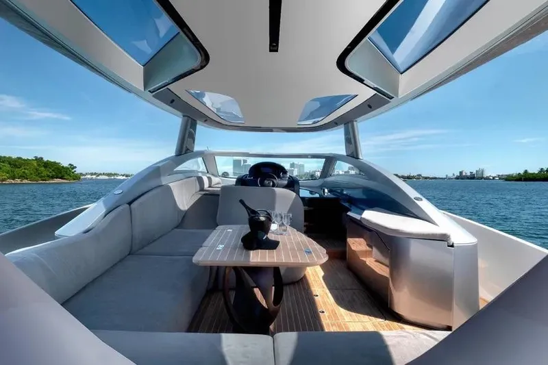  Yacht Photos Pics Luxurious Tecnomar Evo 55 yacht interior with panoramic views, modern seating, and elegant table setting.