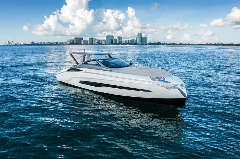  Yacht Photos Pics Luxury Tecnomar Evo 55 yacht cruising on open water, 2017 model, with city skyline backdrop.
