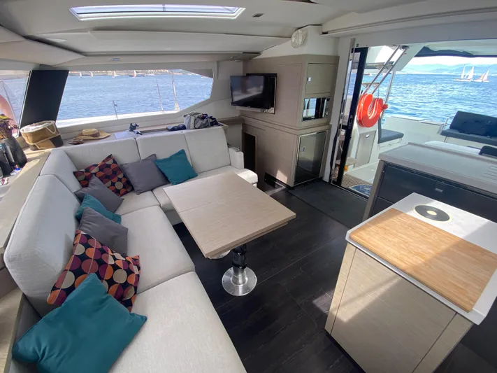 Enotan Yacht Photos Pics Luxurious interior of 2020 Fountaine Pajot Saona 47 catamaran with spacious seating and ocean view.