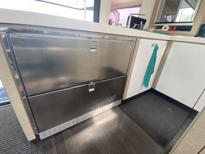 Enotan Yacht Photos Pics Modern kitchen area in 2020 Fountaine Pajot Saona 47 catamaran, featuring stainless steel appliances.