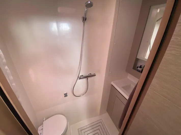 Enotan Yacht Photos Pics Bathroom interior of 2020 Fountaine Pajot Saona 47 yacht, featuring shower and sink.