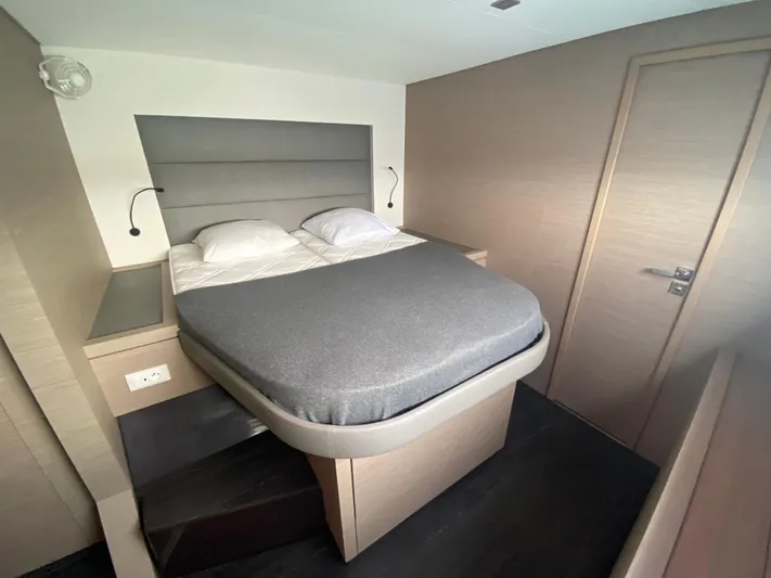 Enotan Yacht Photos Pics Modern bedroom interior on 2020 Fountaine Pajot Saona 47 yacht, featuring a cozy bed.