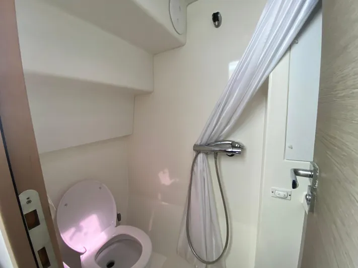 Enotan Yacht Photos Pics Bathroom interior of 2020 Fountaine Pajot Saona 47 yacht, featuring shower and toilet.