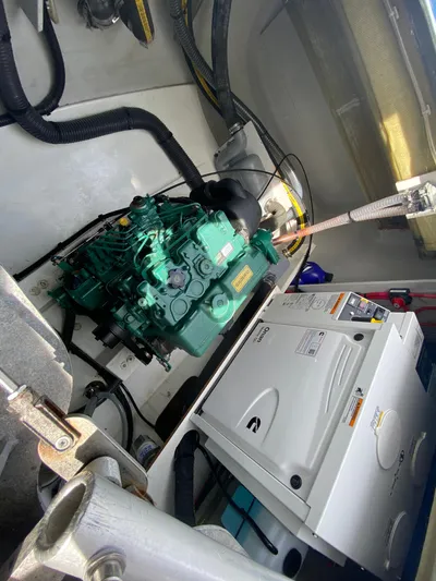 Enotan Yacht Photos Pics Engine room of 2020 Fountaine Pajot Saona 47 catamaran, featuring a green engine and equipment.