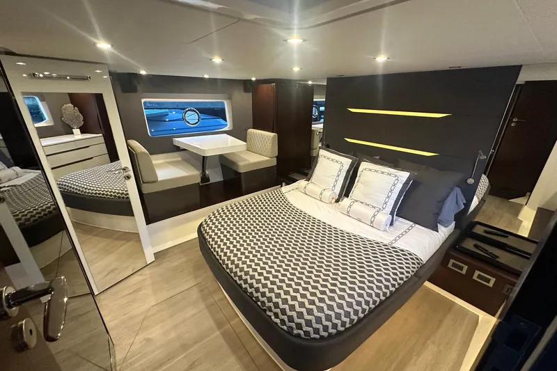 American Dream Yacht Photos Pics Luxurious interior of 2023 Schaefer 660 yacht with modern bedroom and dining area.