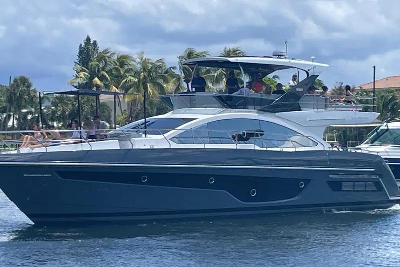 American Dream Yacht Photos Pics Luxury Schaefer 660 yacht cruising on water, 2023 model, with passengers enjoying the view.