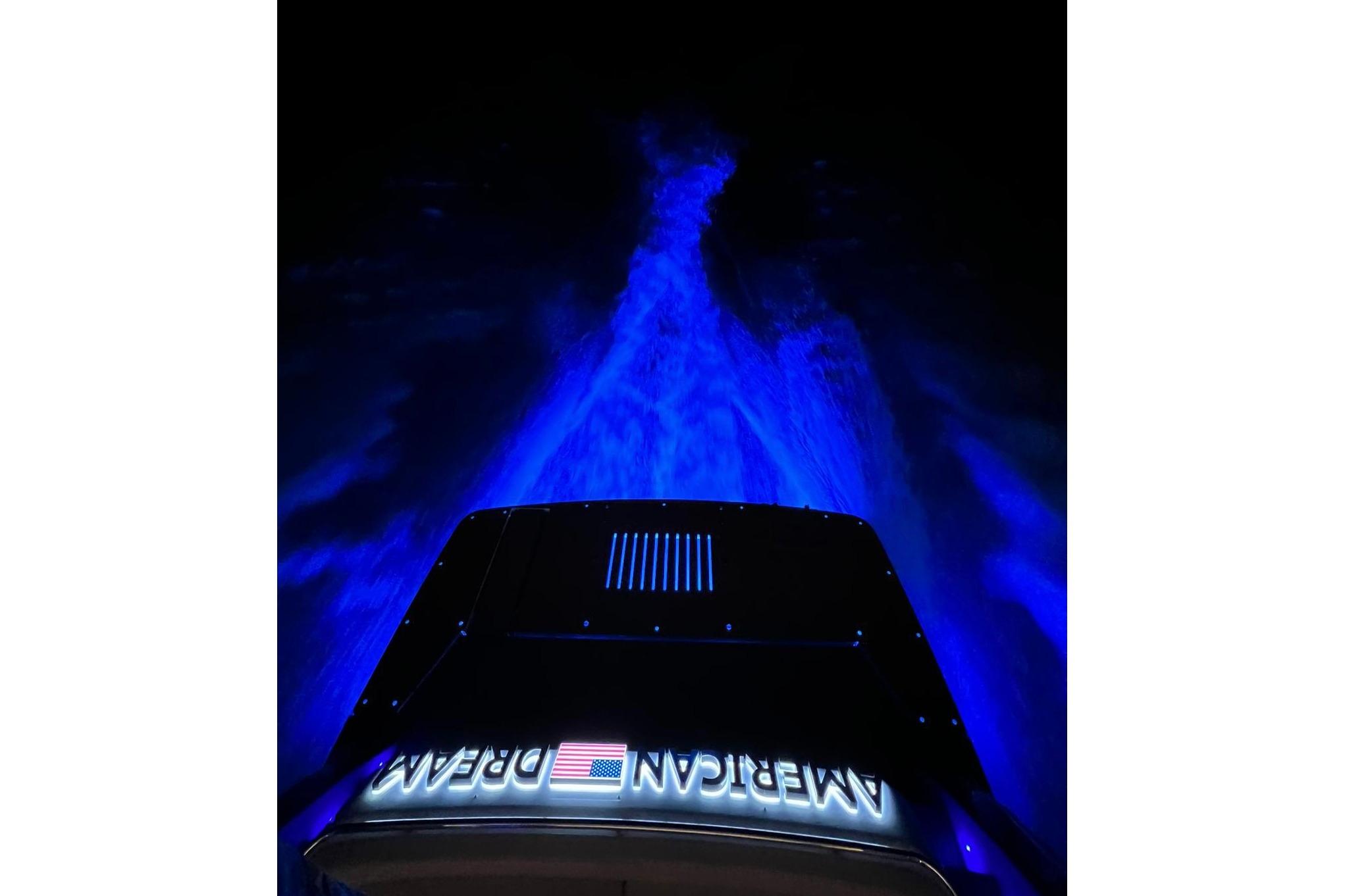 Schaefer 660 boat with blue underwater lights, 2023 model, "American Dream" text visible.
