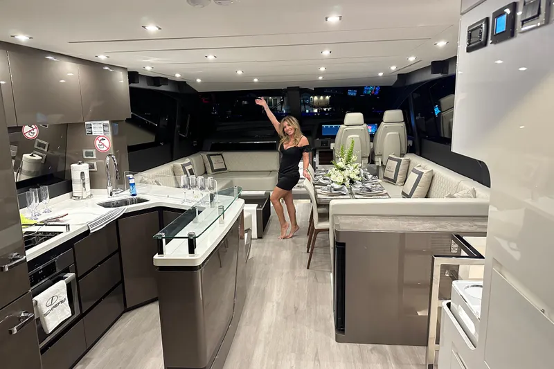 American Dream Yacht Photos Pics Luxurious interior of 2023 Schaefer 660 yacht with modern kitchen and elegant dining area.