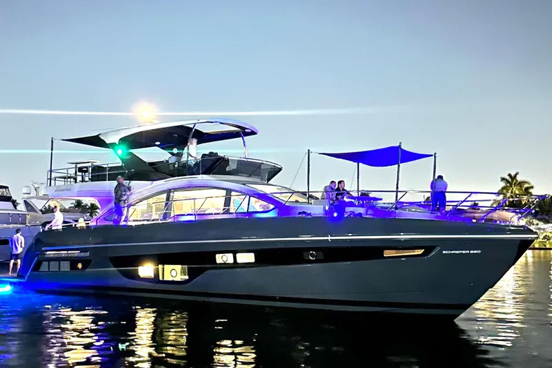 American Dream Yacht Photos Pics Luxurious 2023 Schaefer 660 yacht illuminated at night on the water.