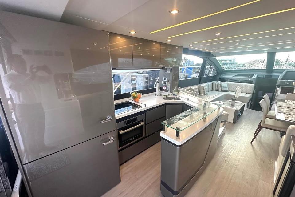 Luxurious interior of 2023 Schaefer 660 yacht with modern kitchen and seating area.