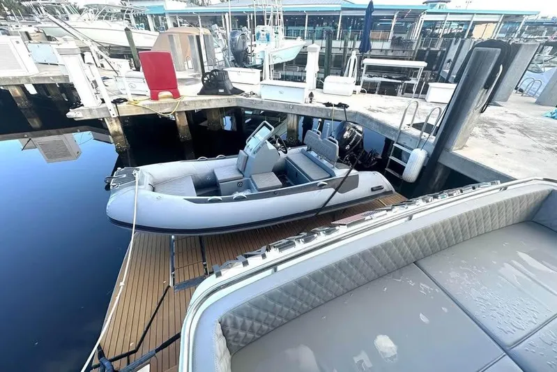 American Dream Yacht Photos Pics 2023 Schaefer 660 inflatable boat docked at a marina with surrounding vessels.