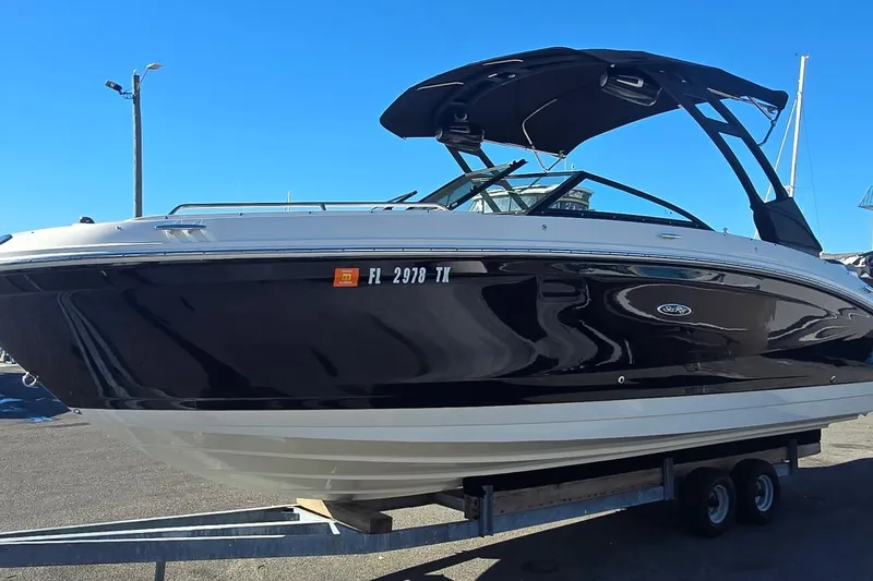  Yacht Photos Pics 2023 Sea Ray SDX 270 Outboard boat on trailer under clear blue sky.