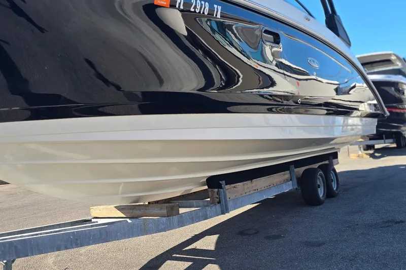  Yacht Photos Pics 2023 Sea Ray SDX 270 Outboard boat on trailer, sleek black and white design.