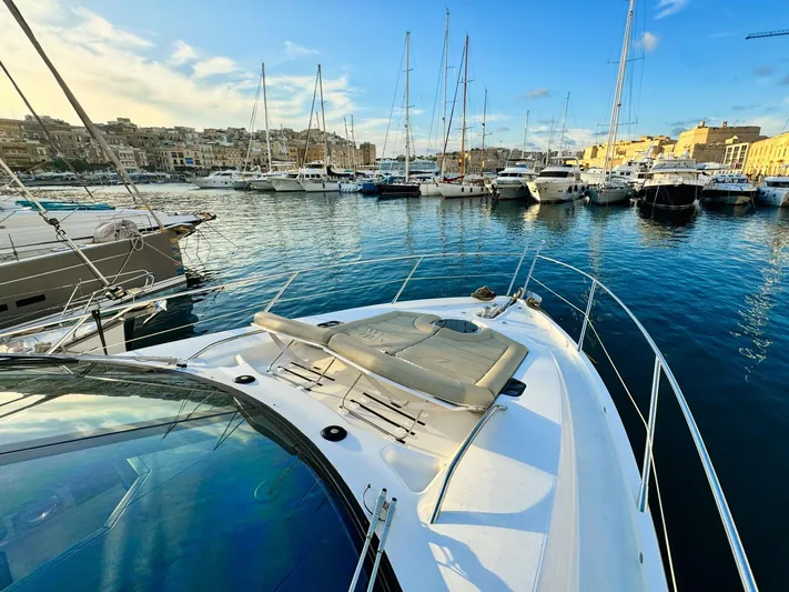 The Office Yacht Photos Pics Sunseeker Manhattan 55 yacht docked in a marina, 2015 model, with clear blue skies.