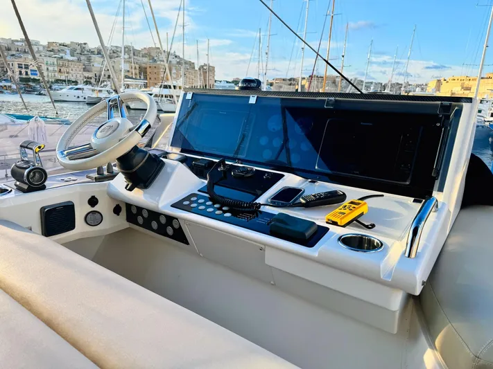 The Office Yacht Photos Pics Sunseeker Manhattan 55 yacht helm with modern controls, docked in a marina, 2015 model.