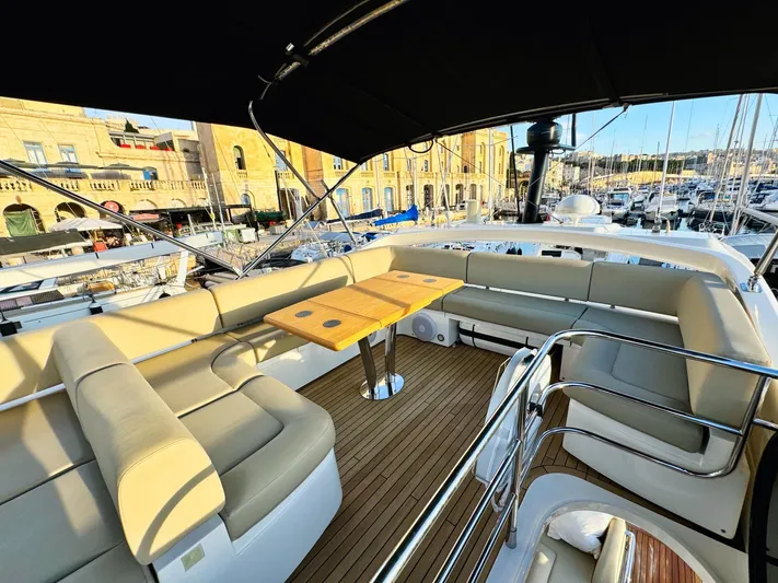 The Office Yacht Photos Pics Luxurious Sunseeker Manhattan 55 yacht interior, 2015 model, featuring elegant seating and wooden deck.