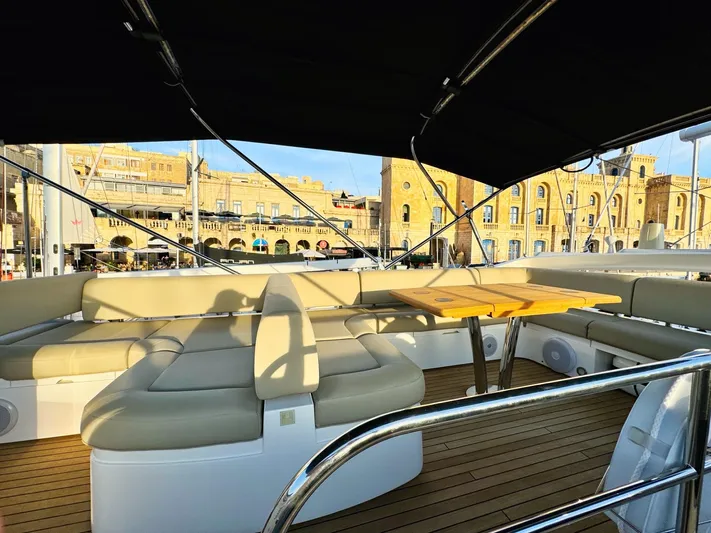 The Office Yacht Photos Pics Luxurious Sunseeker Manhattan 55 yacht interior, 2015 model, featuring elegant seating and wooden deck.