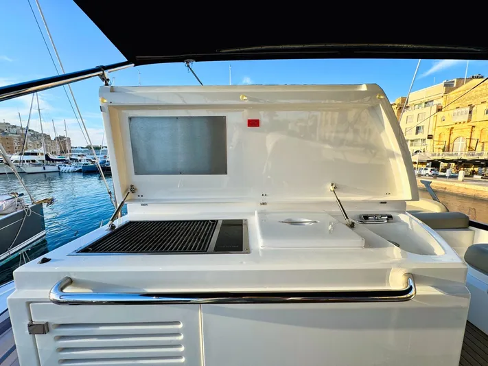 The Office Yacht Photos Pics Outdoor kitchen on a 2015 Sunseeker Manhattan 55 yacht, docked at a marina.