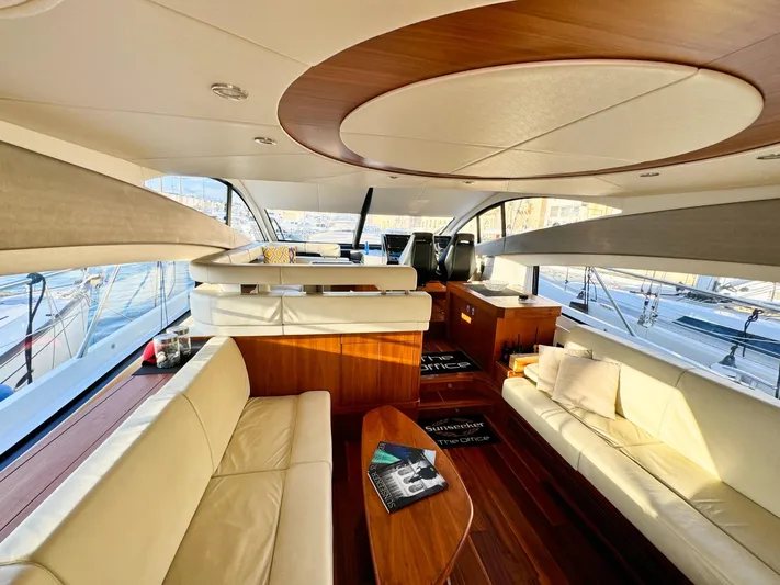 The Office Yacht Photos Pics Luxurious interior of 2015 Sunseeker Manhattan 55 yacht with elegant seating and wood accents.
