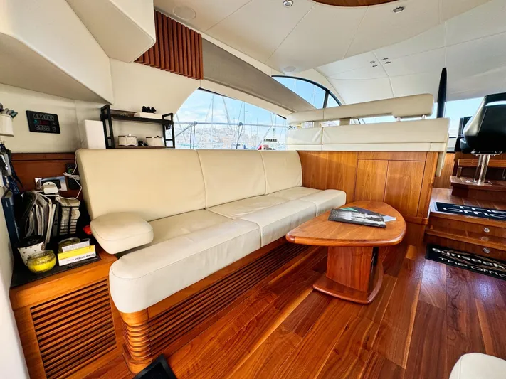 The Office Yacht Photos Pics Luxurious interior of 2015 Sunseeker Manhattan 55 yacht with cream sofa and wooden accents.